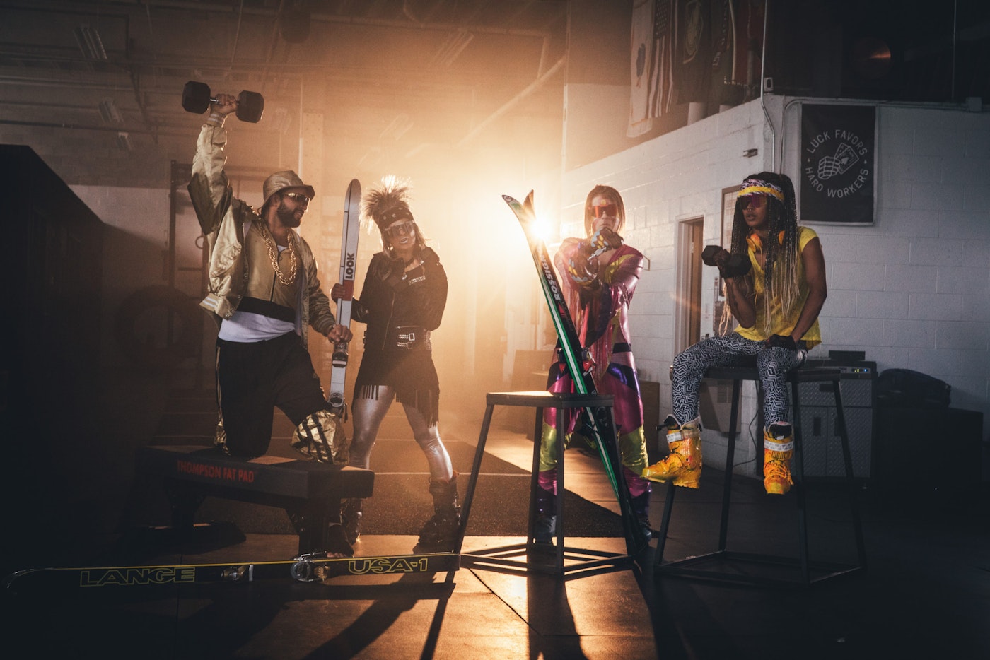 Skiers posing for a portrait with dramatic lighting