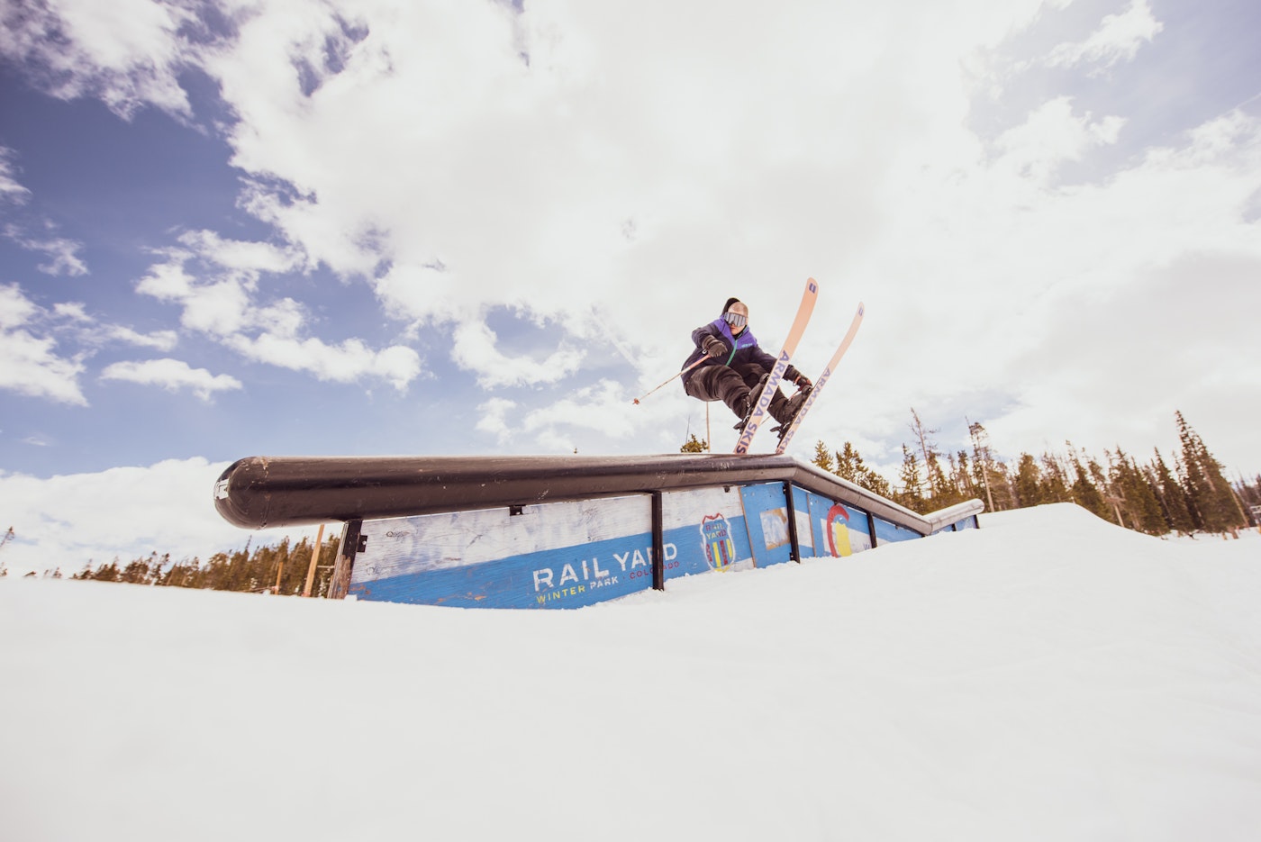 Skier hitting a rail at Winter Park Resort.