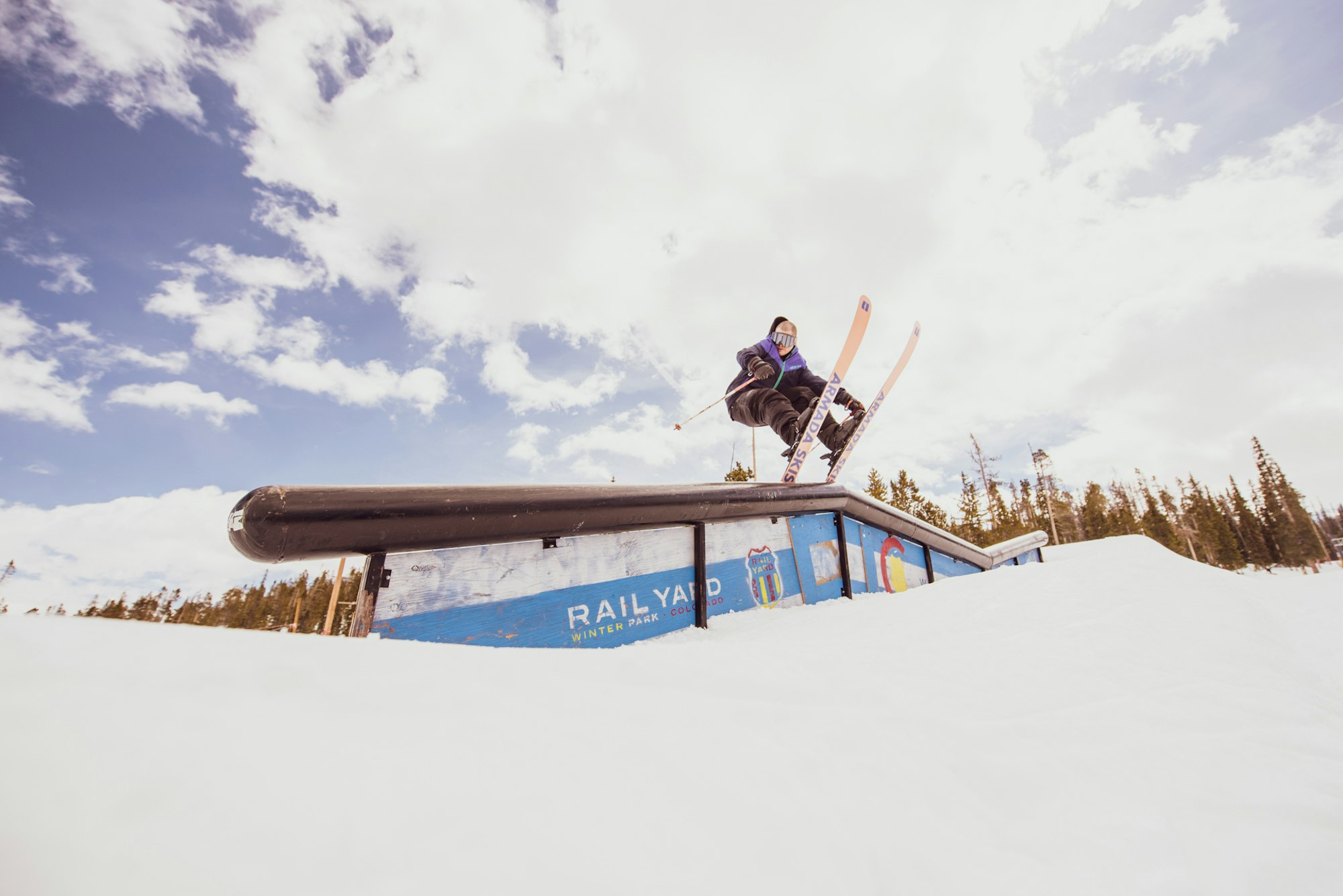 Skier hitting a rail at Winter Park Resort.