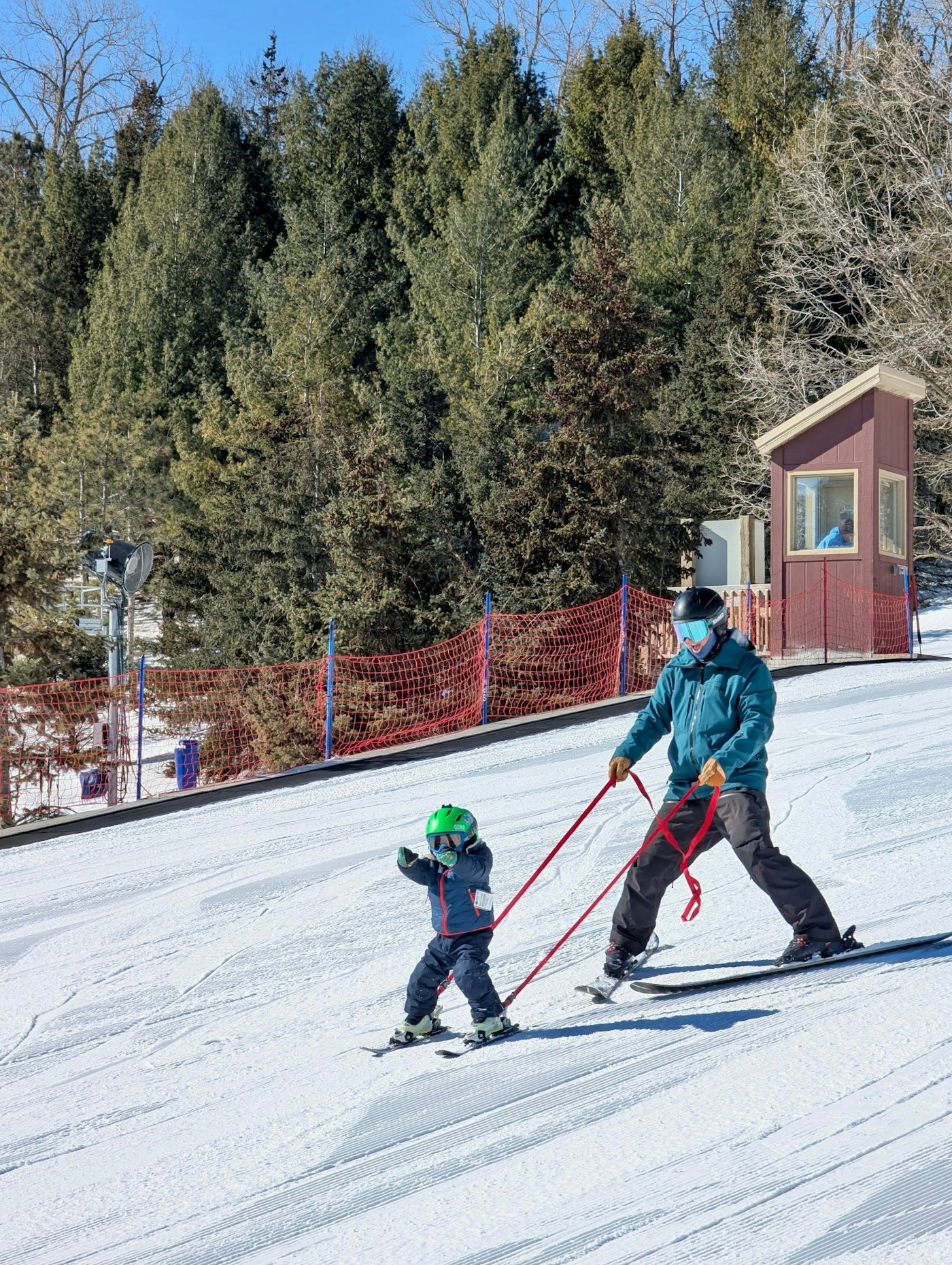 Dad and child using Snap Two Ski Tether.