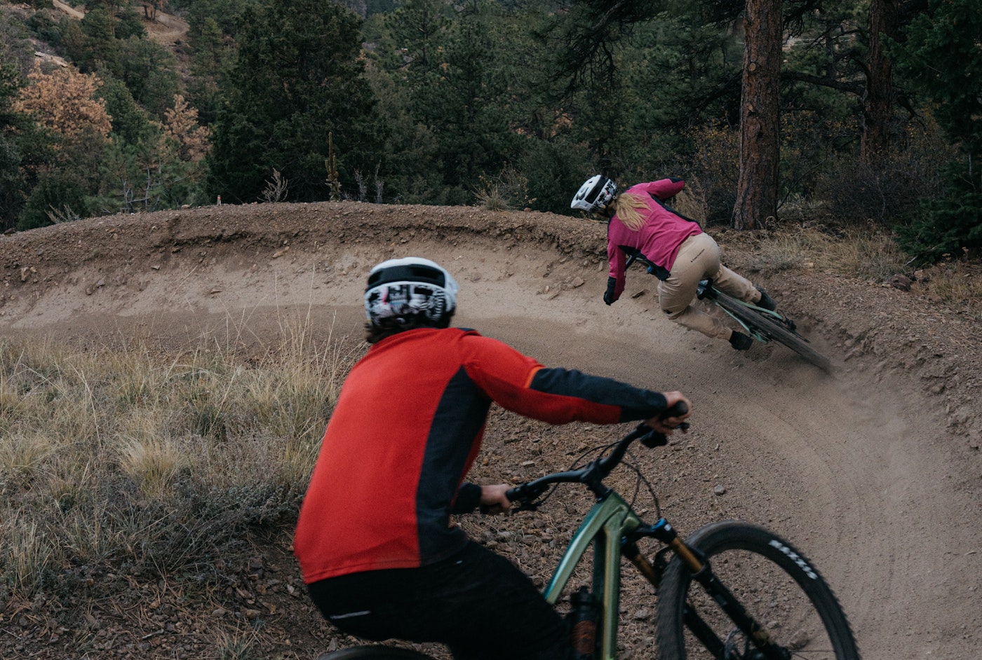 Mountain bikers on a pump track.