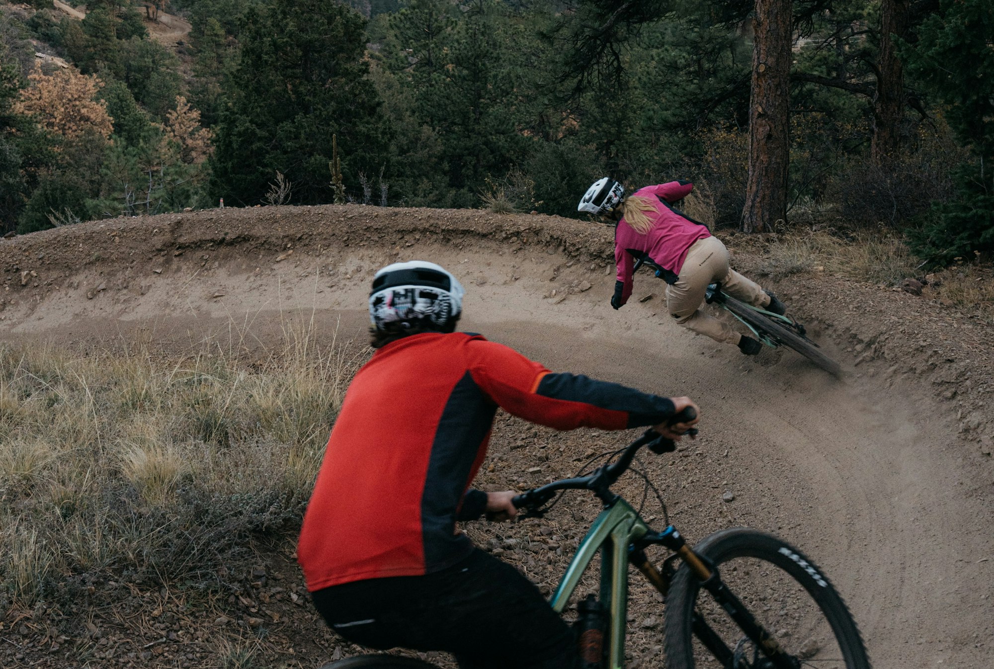 Mountain bikers on a pump track.