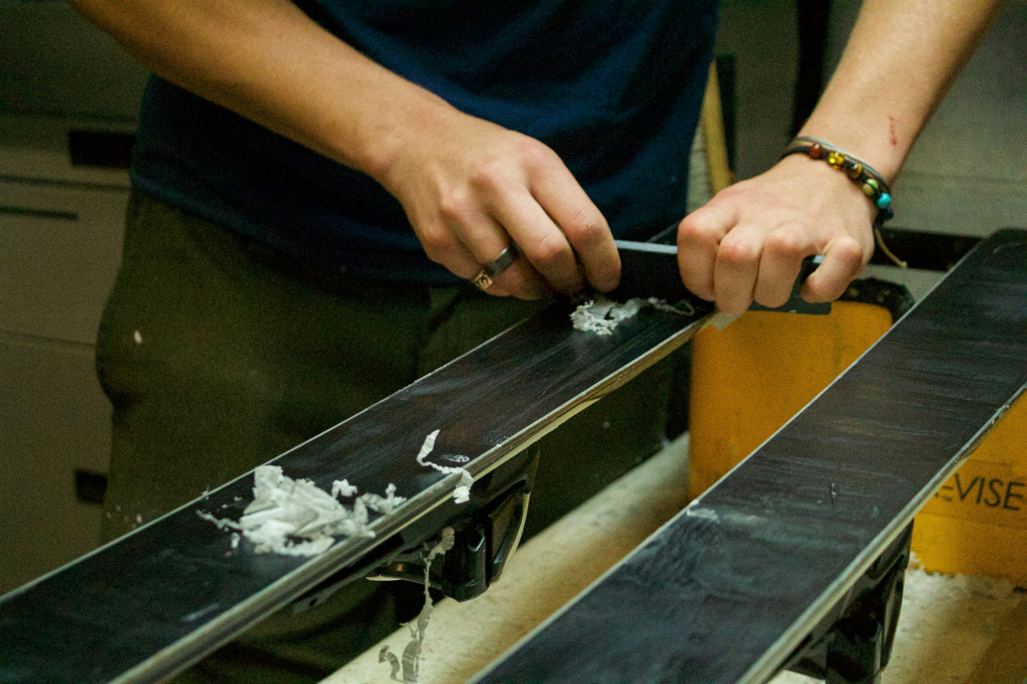 Scraping off excess wax.