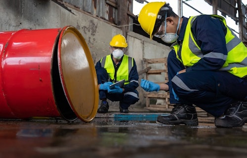 Workers inspecting contaminated water