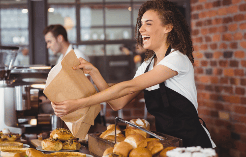 Female server handing food to customer