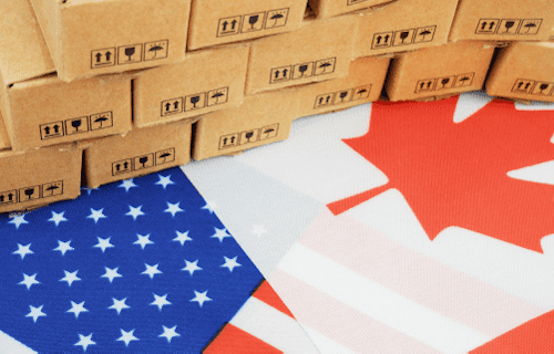 American (US) flag superphone by Canadian flag with a pile of boxes on top