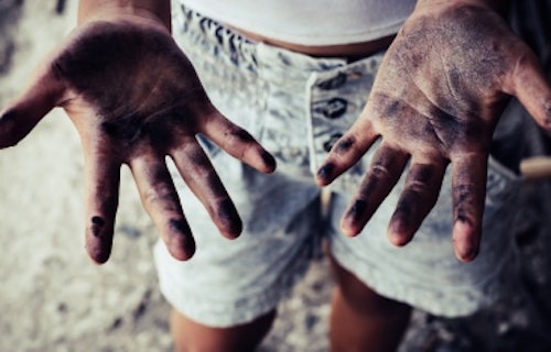 Child laborer with sooty hands