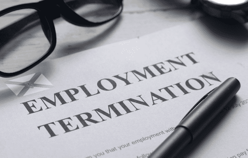 Employment notice on a desk with glasses and pen lying on top of it.