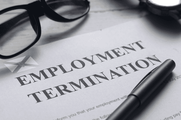 Employment notice on a desk with glasses and pen lying on top of it.
