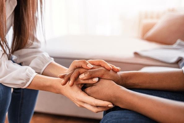 Woman comforting colleague who has experienced loss