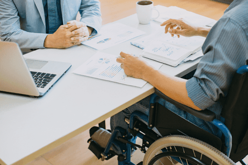 Photo of worker in a wheelchair discussing return-to-work plans with employer