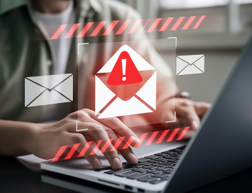 Image of employee on laptop opening unsafe email links