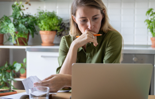 Plant shop owner sitting at a table reviewing finances