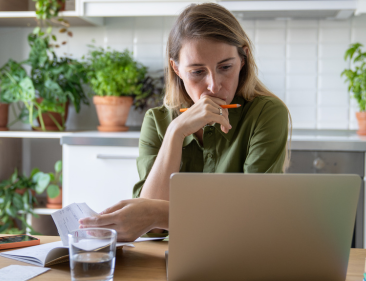 Plant shop owner sitting at a table reviewing finances