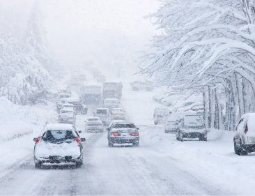 Traffic on the road moving slowly during heavy snowfall