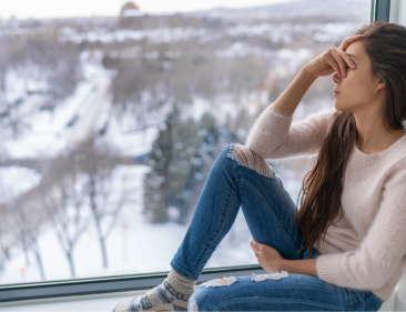 An employee struggling with SAD sitting by the window