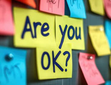 A softboard with colourful post-its that say: Are you ok?