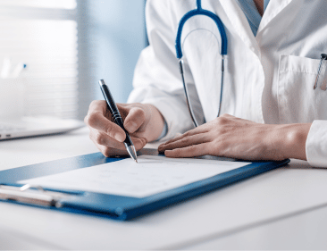 A doctor signing a sick note in a clinic.