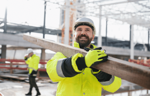 Worker in a high visibility vest at a construction site.