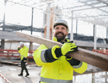 Worker in a high visibility vest at a construction site.