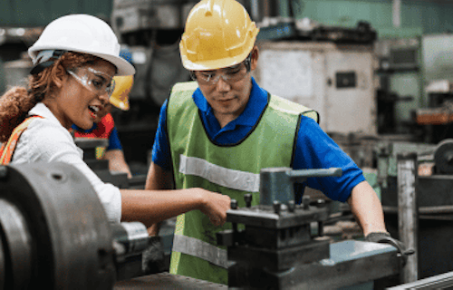 Small business owner helping employee