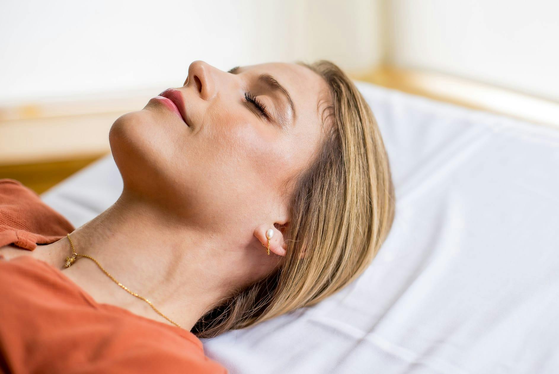 woman laying down for facial procedure
