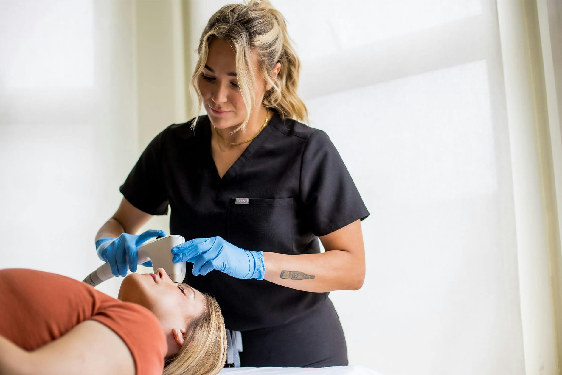 woman getting facial laser procedure