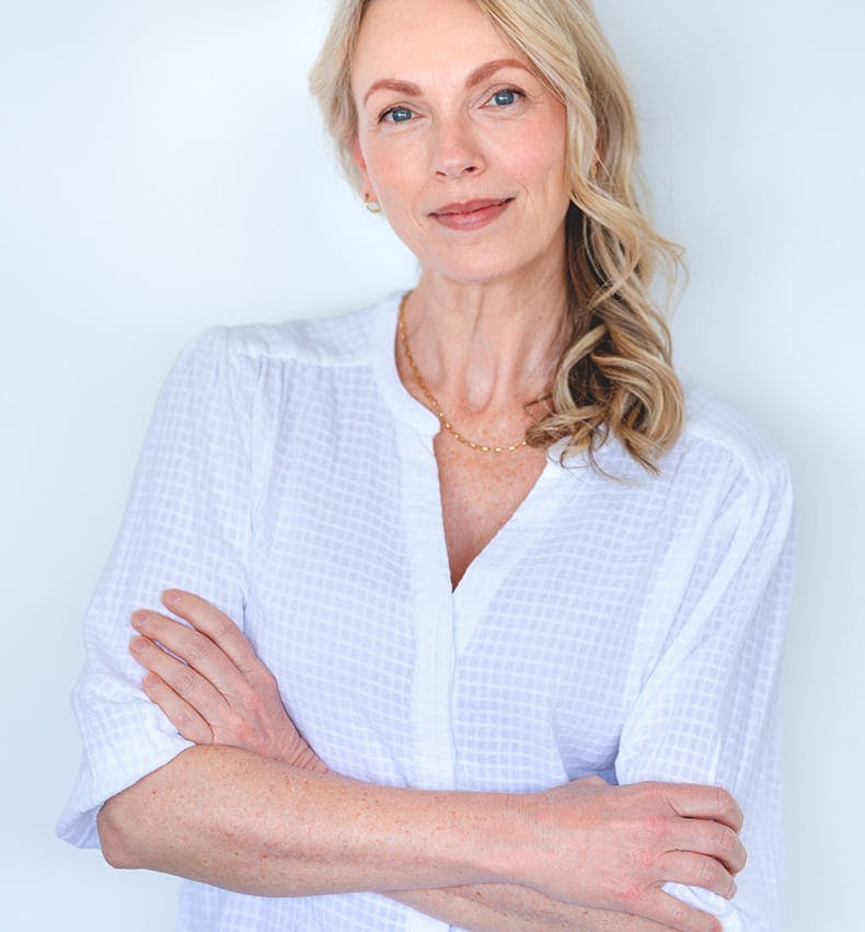 woman in white shirt crossing her arms