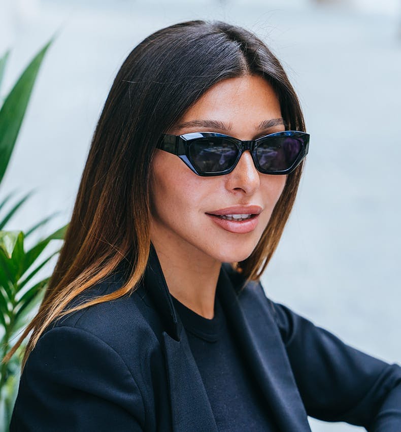 woman with black suit and black sunglasses on