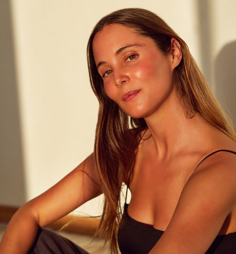 woman tilting her head slightly with the sunlight hitting her skin