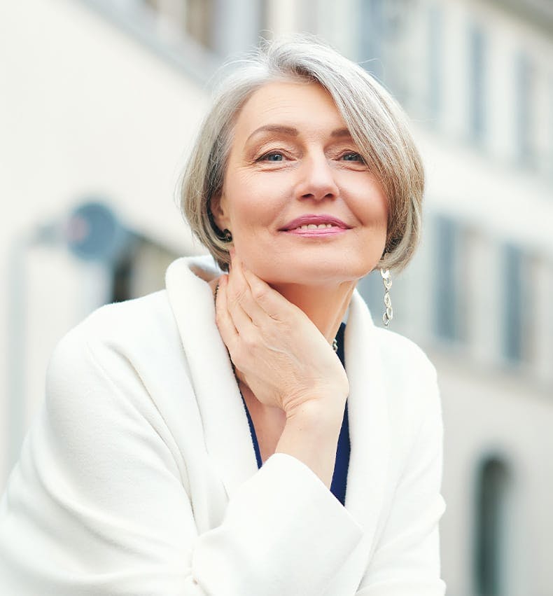 older woman wearing a white jacket