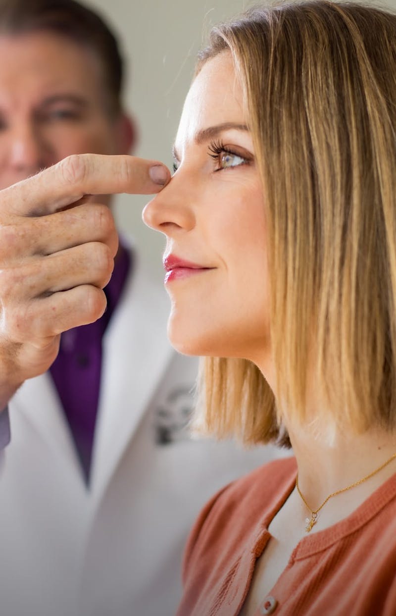 Dr. Maas looking at a female's nose