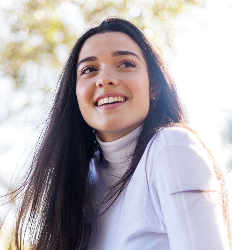 woman in white turtleneck smiling