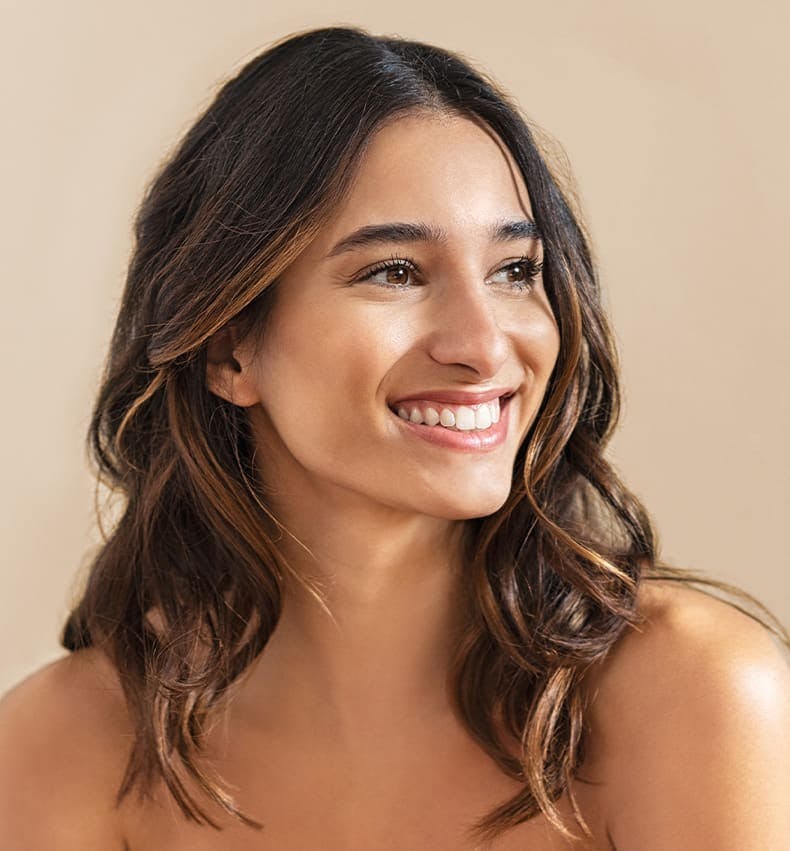 woman with wavy brown hair smiling