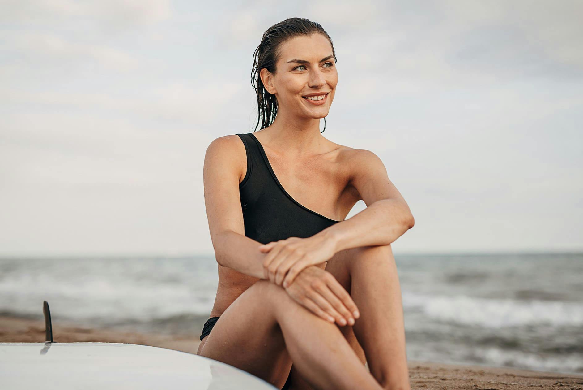 woman sitting on the sand at the beach