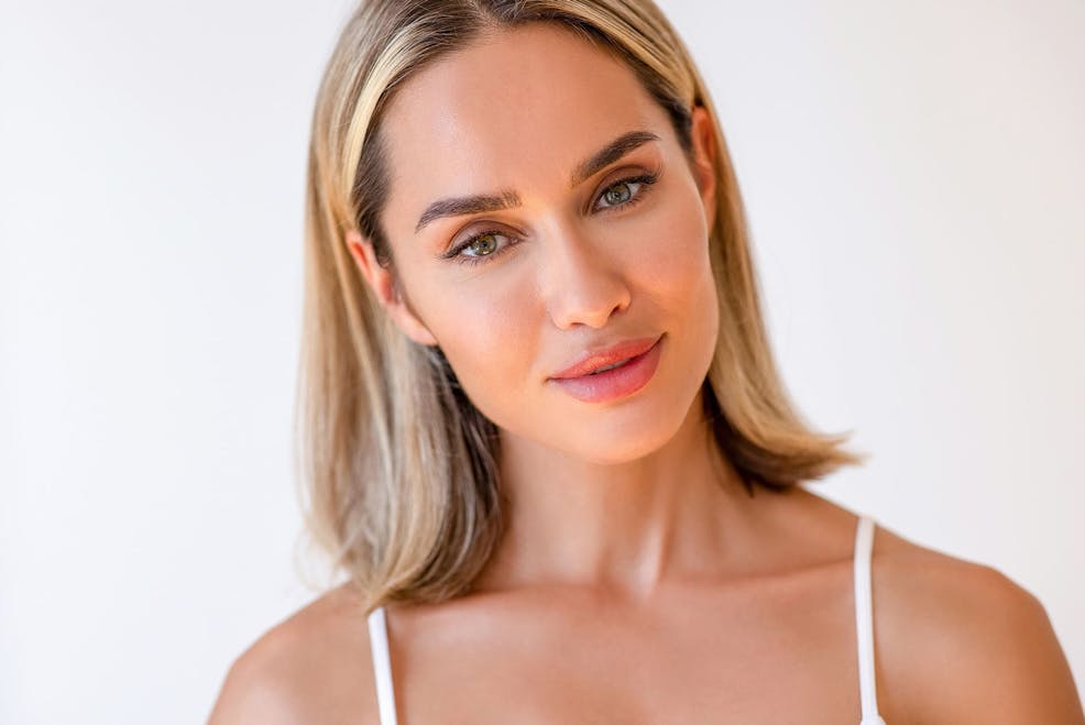 woman looking forward and tilting her head slightly