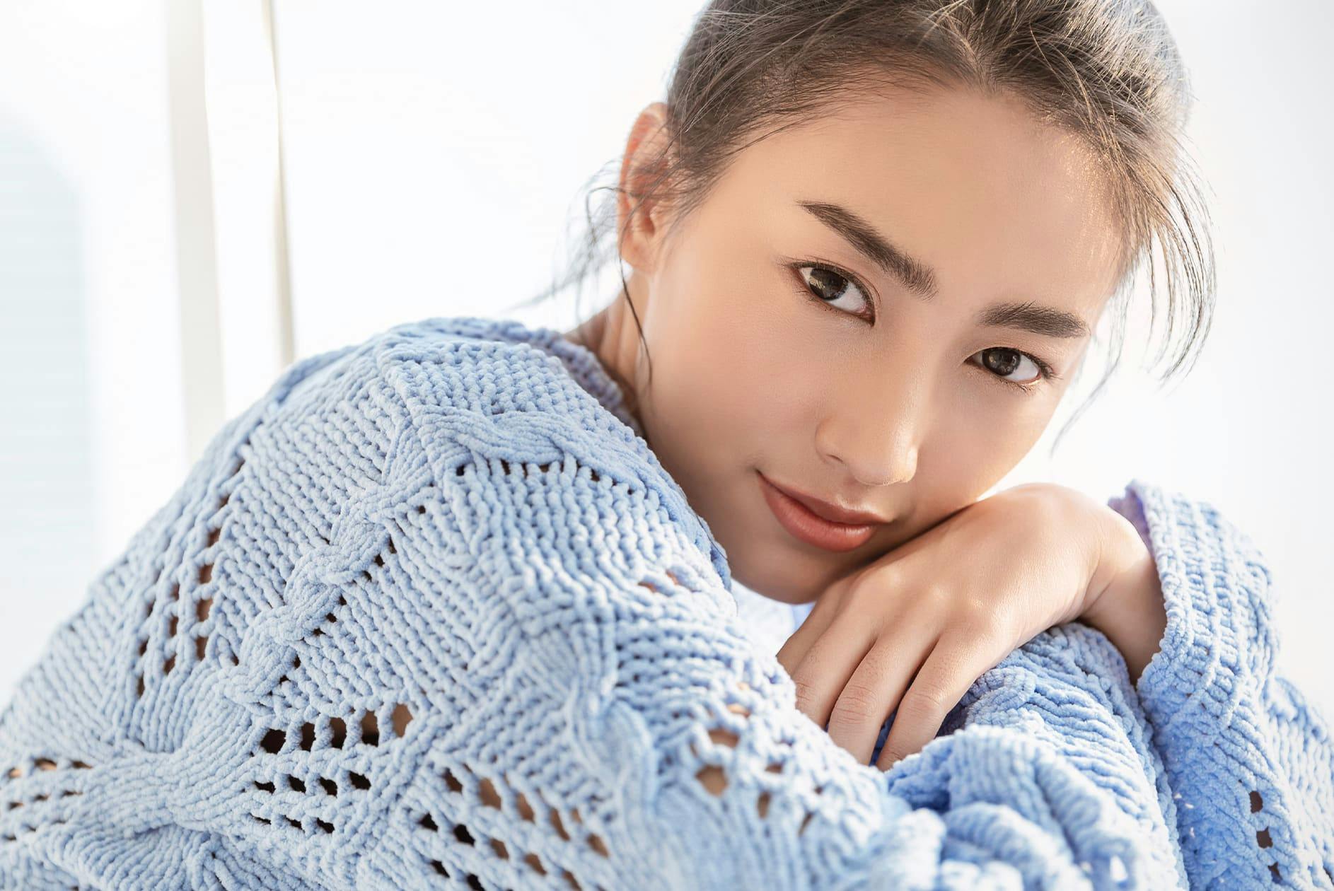 woman in light blue sweater