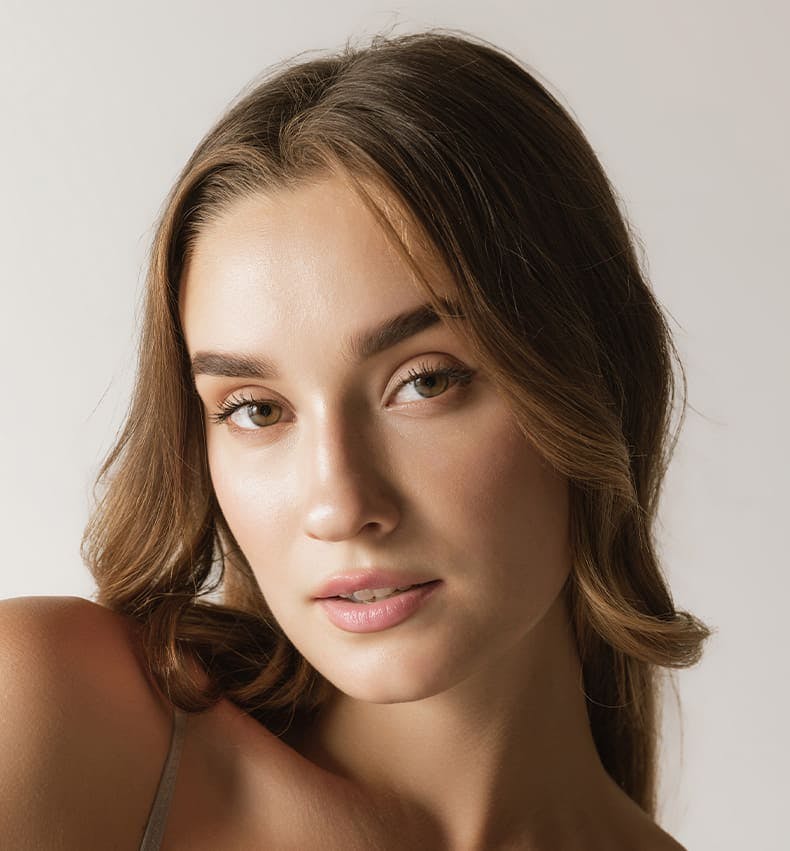 close up on woman with her hair back looking forward