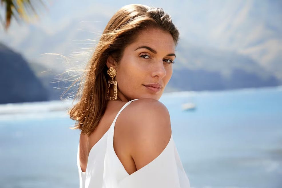 woman looking over her shoulder while outside