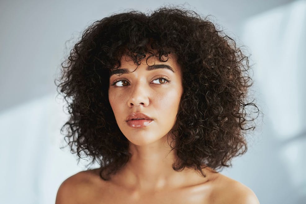 woman with afro looking to the right