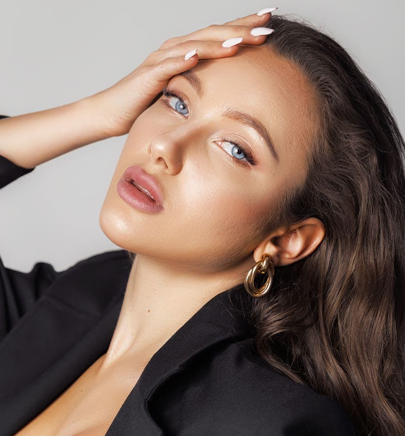 woman tilting her head back with her hand on her forehead