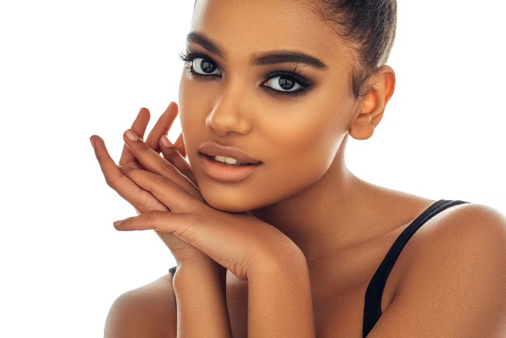 woman with her hands under her chin