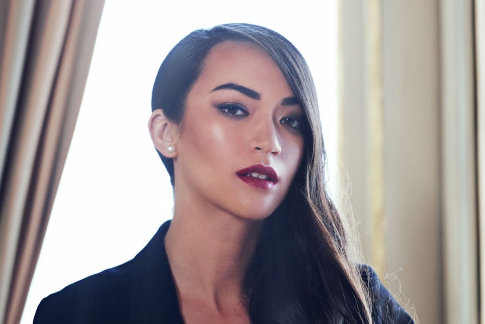 woman with smokey eye shadow and red lips with hair on one side of her head