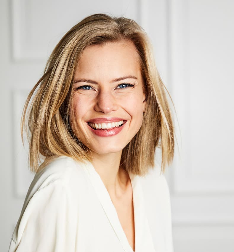 woman with short blonde bob smiling