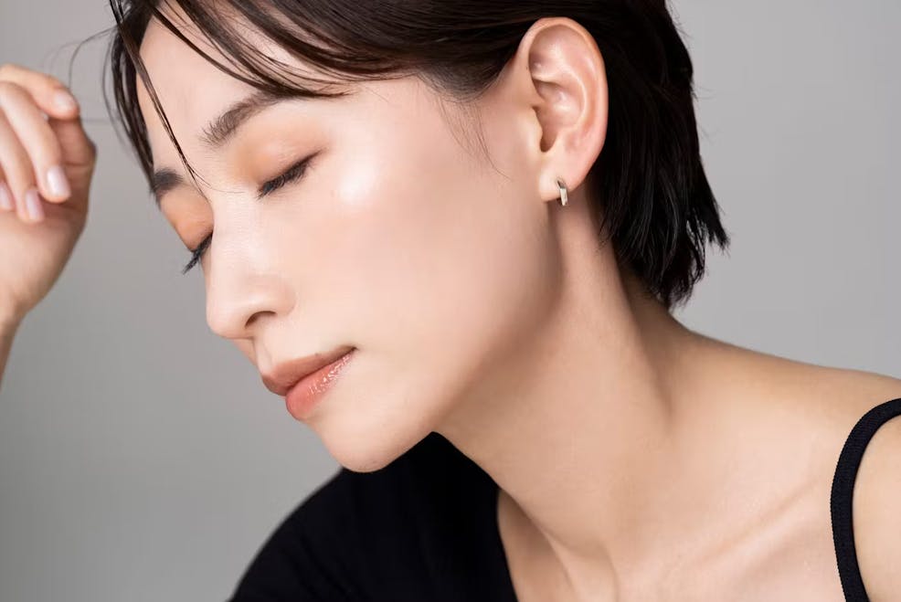 woman leaning her head forward with her eyes closed