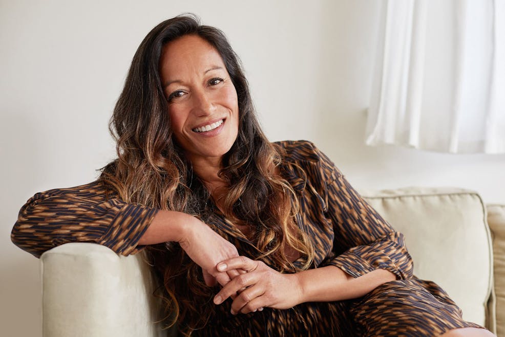 woman smiling and leaning on the couch
