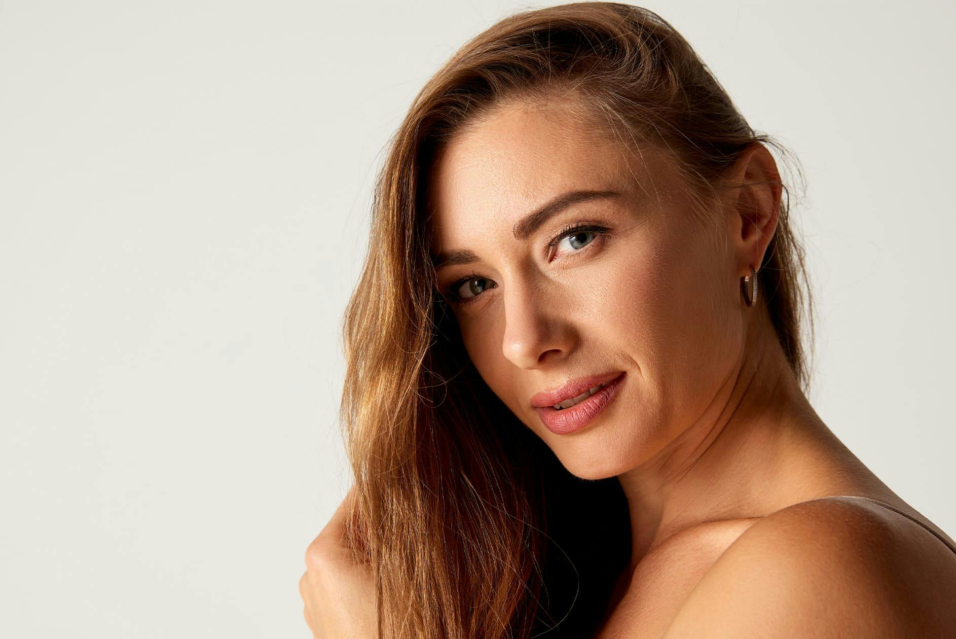 woman looking forward with her hair thrown to one side