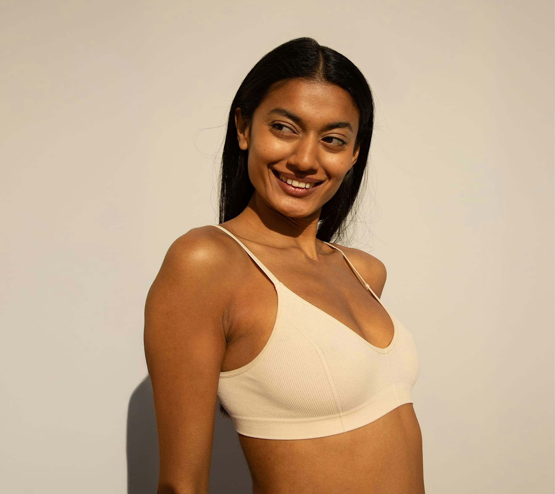 woman smiling in white bra
