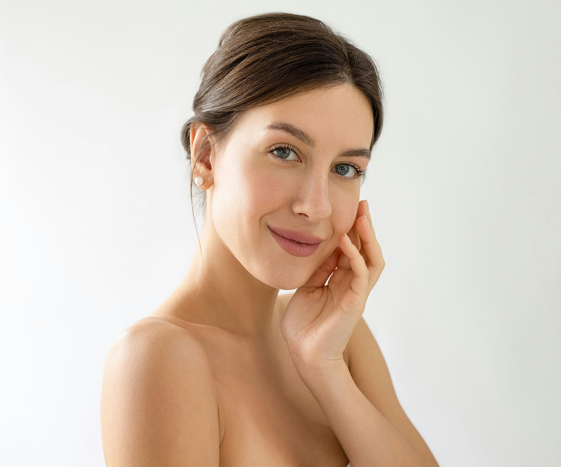 woman smiling with her hand on her cheek