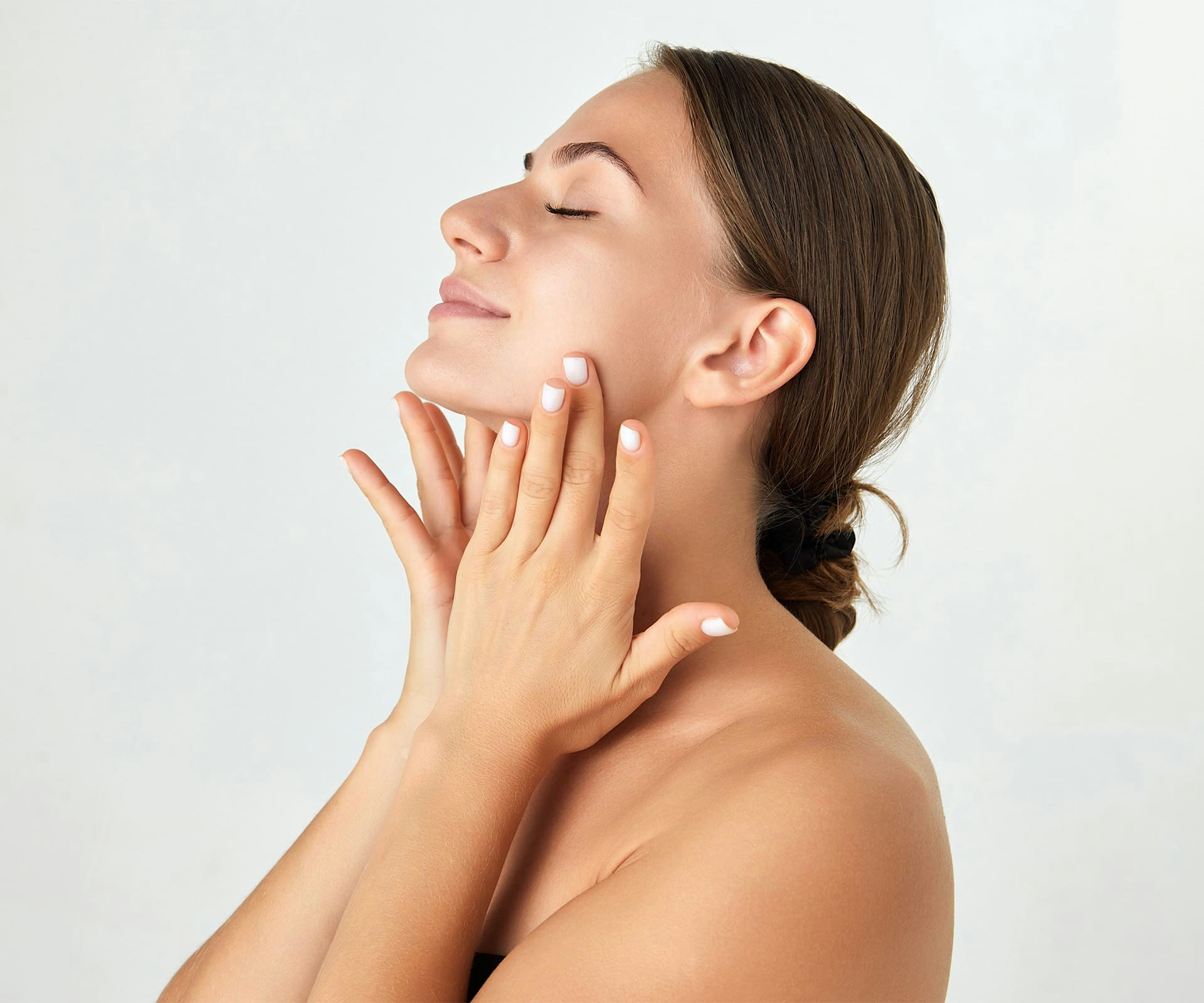 woman touching the side of her face